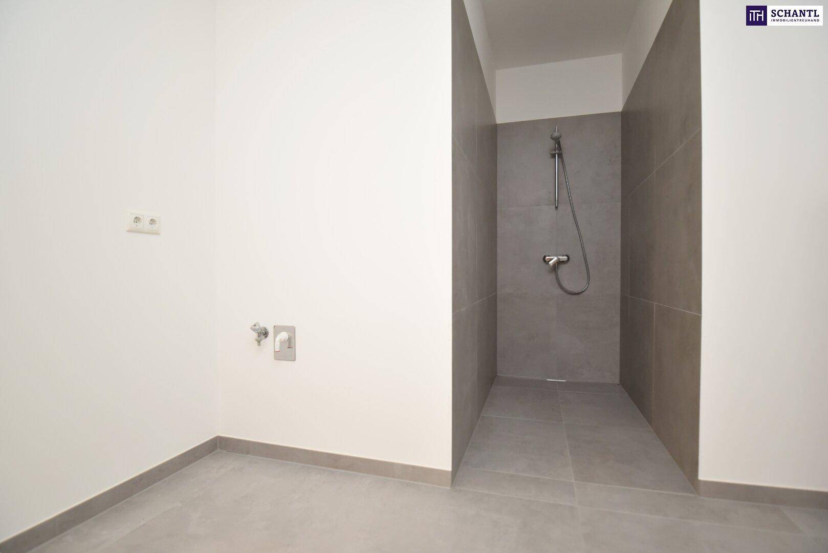Modernes Badezimmer im Rohbau mit begehbarer Dusche und Anschlüssen für Waschbecken.