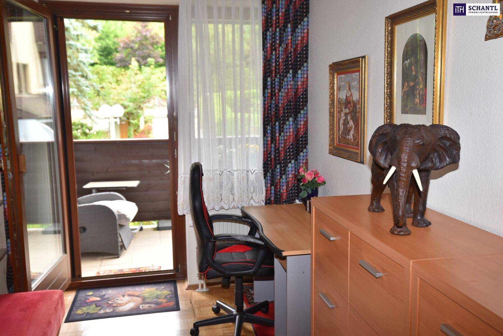 Arbeitsbereich mit Schreibtisch und Bürostuhl, direktem Zugang zu einem Balkon mit Außenblick.