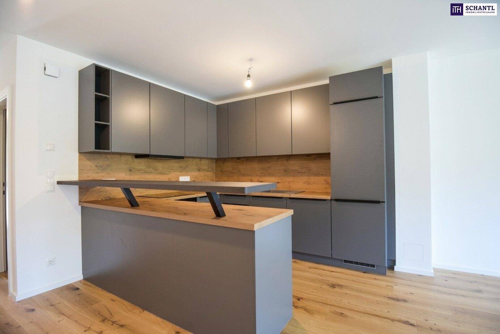 Moderne Küche mit grauen Schränken, Holzdetails und einer integrierten Frühstücksbar.