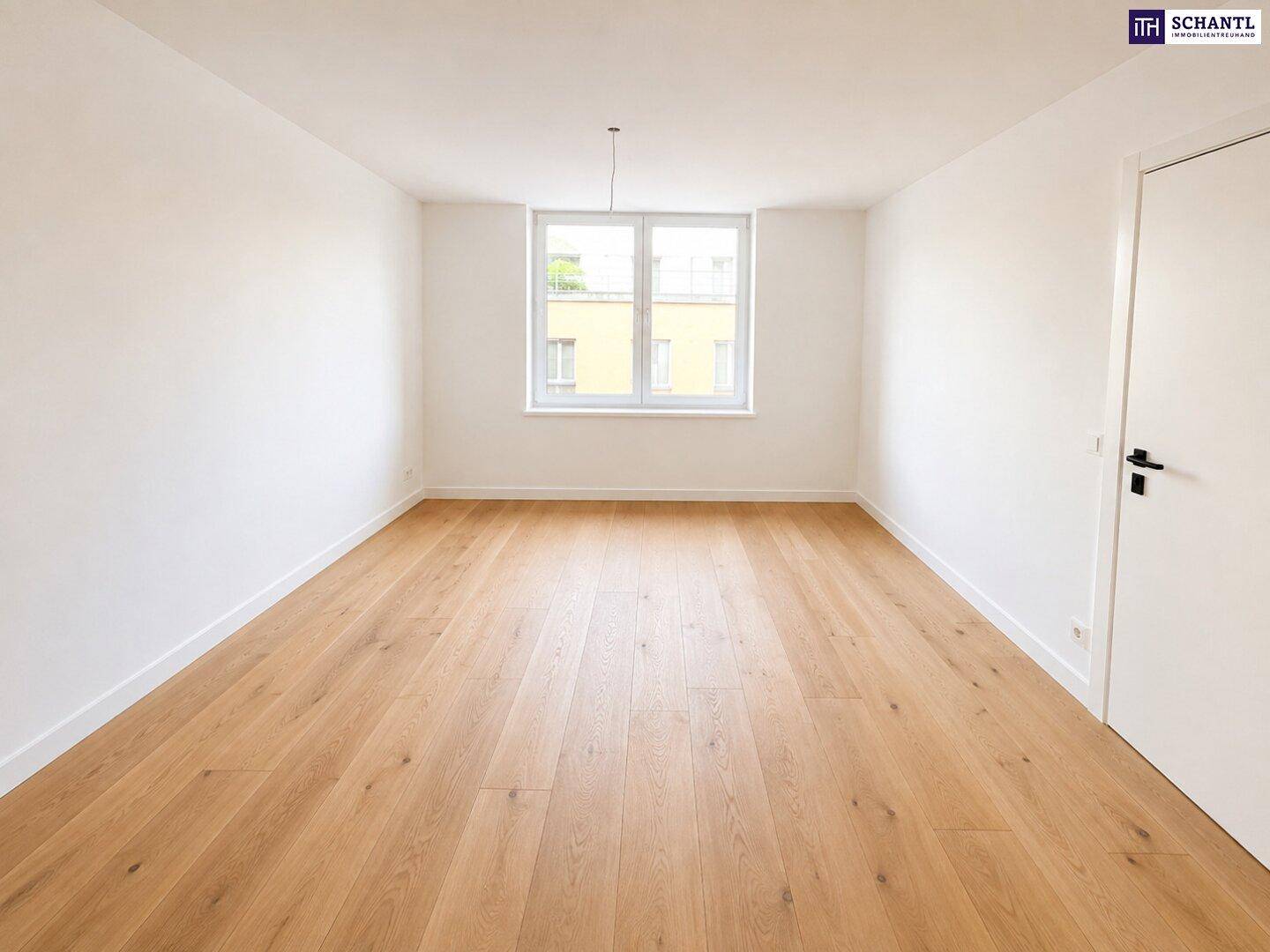 Geräumiger, heller Raum mit Holzparkettboden und großem Fenster, vielseitig nutzbar.