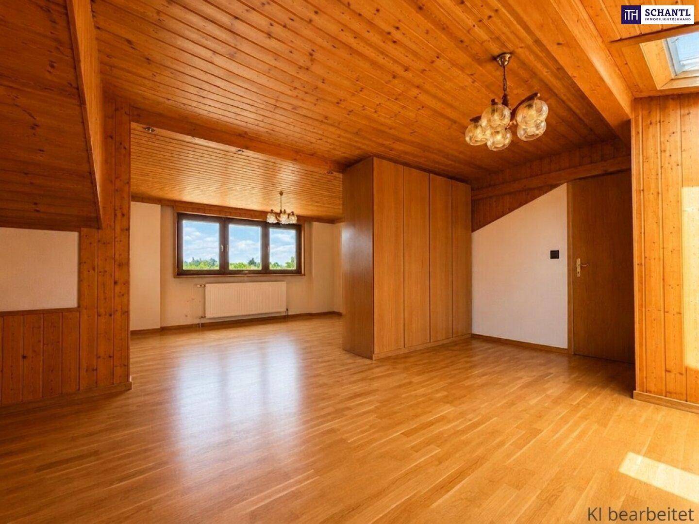 Geräumiges Zimmer mit Holzboden, Holzverkleidung, Einbauschrank und Dachschräge.