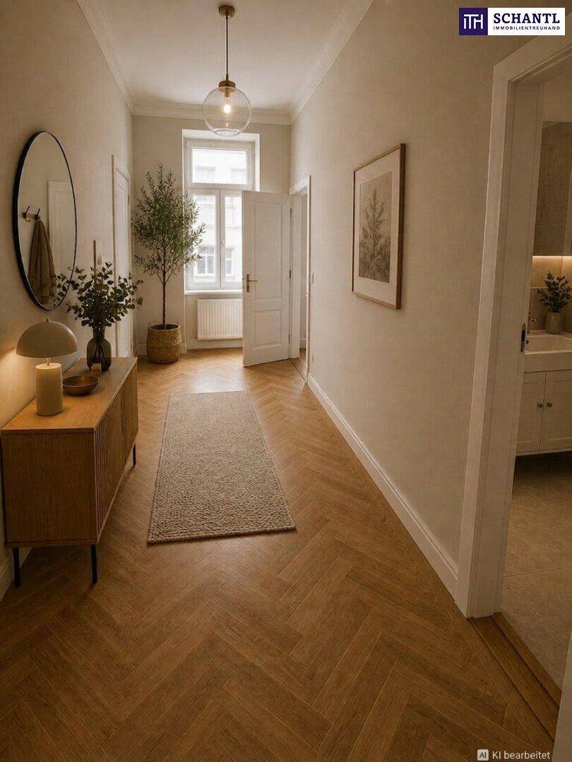 Heller Flur mit stilvollem Fischgrätparkett, einem eleganten Spiegel und natürlichem Lichteinfall.