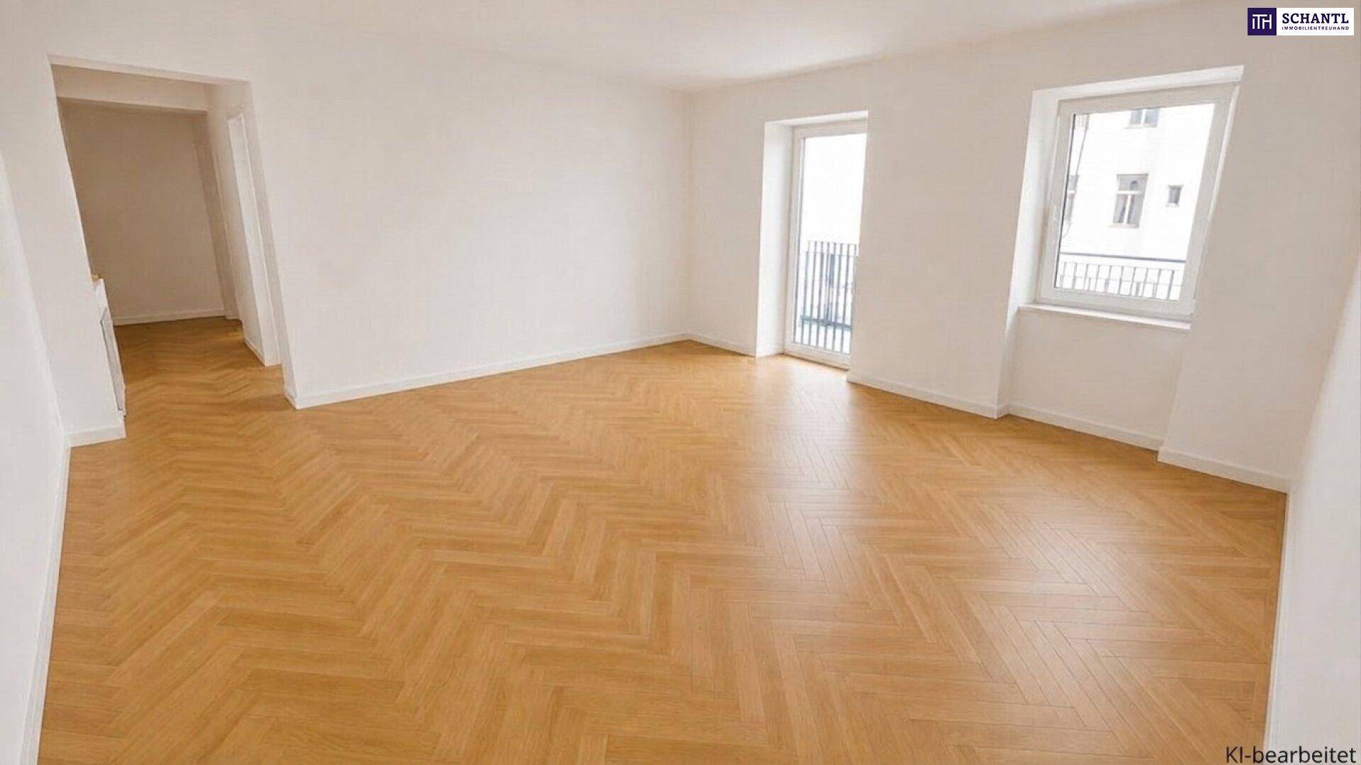 Helles, leeres Wohnzimmer mit Fischgrätparkett und Zugang zu einem französischen Balkon.