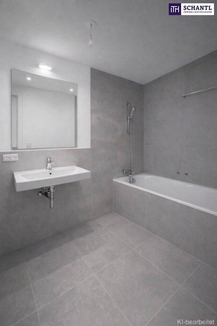 Modernes Badezimmer mit grauen Fliesen, Badewanne und Waschtisch.