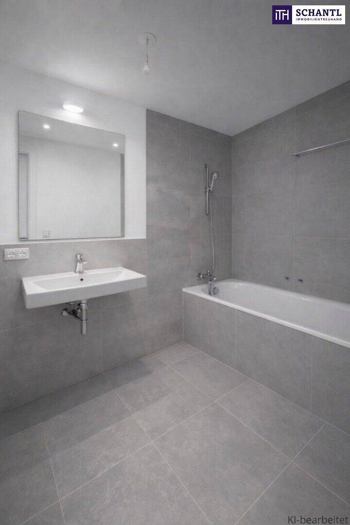 Modernes Badezimmer mit grauen Fliesen, Waschbecken und integrierter Badewanne.
