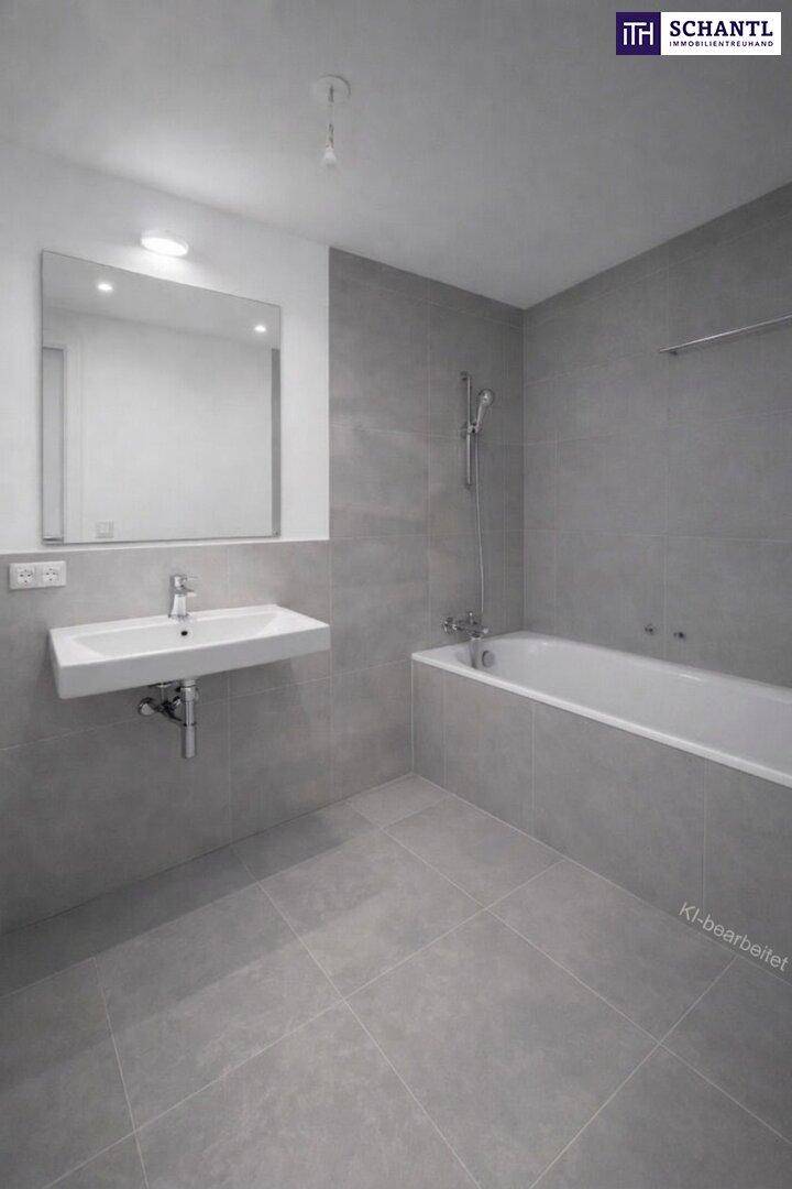 Modernes Badezimmer mit grauen Fliesen, wandhängendem Waschbecken und integrierter Badewanne.