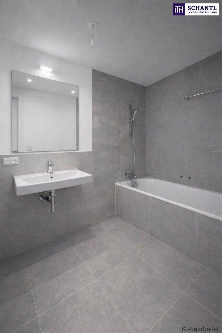 Modernes Badezimmer mit grauen Fliesen, wandmontiertem Waschbecken und Badewanne mit Duschfunktion.