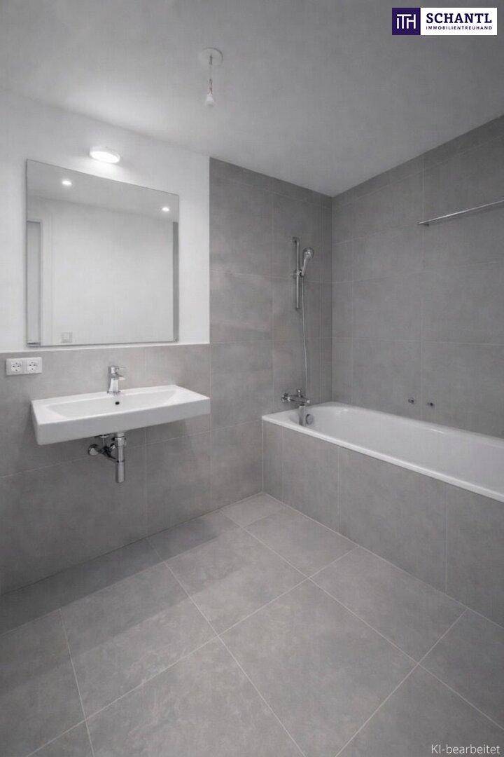 Modernes Badezimmer mit grauen Fliesen, einer Badewanne und einem wandmontierten Waschbecken.