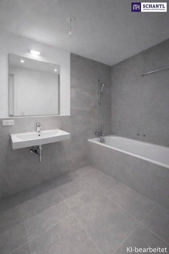 Modernes Badezimmer mit grauen Fliesen, Waschtisch und integrierter Badewanne.