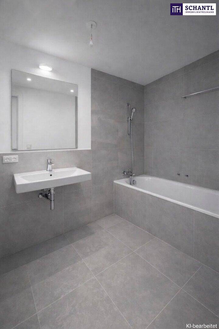 Modernes Badezimmer mit grauen Fliesen, wandhängendem Waschbecken und integrierter Badewanne.