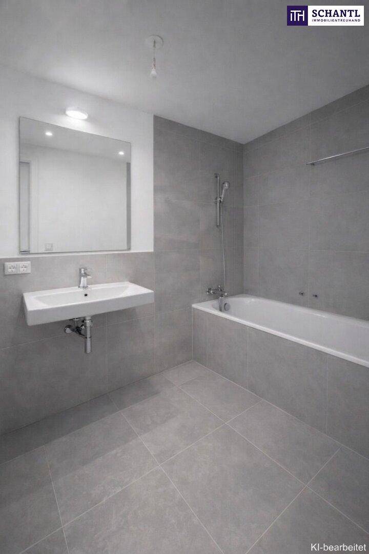 Modernes Badezimmer mit grauen Fliesen, wandhängendem Waschbecken und einer Badewanne mit Duschfunktion.