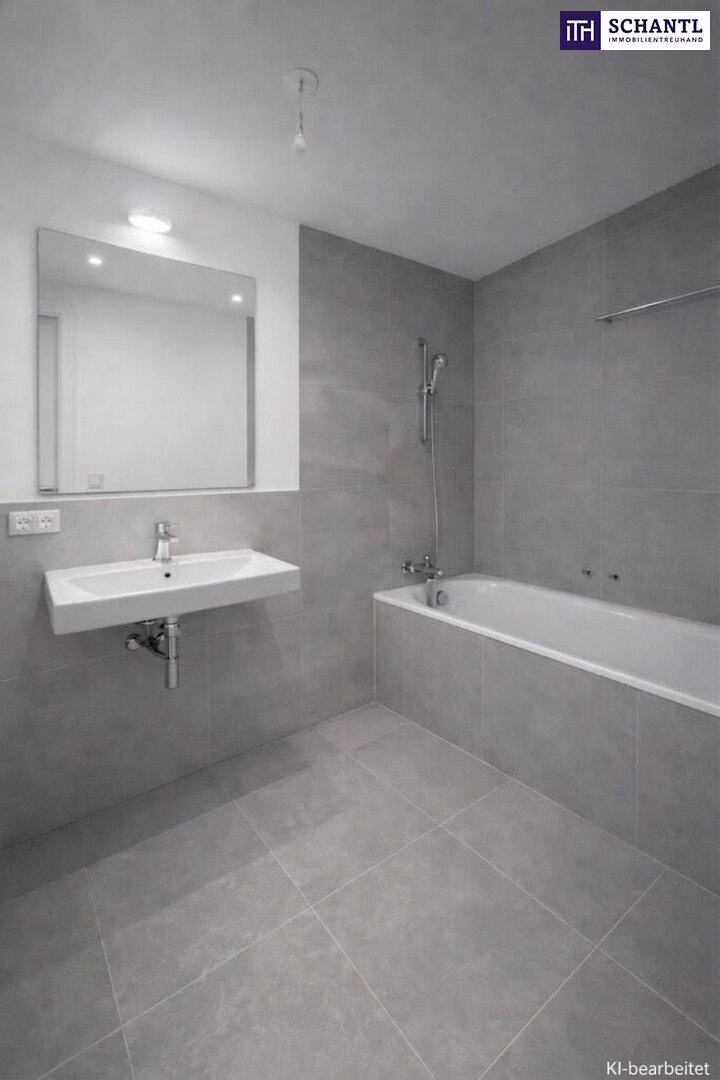 Modernes Badezimmer mit grauen Fliesen, Badewanne und schwebendem Waschtisch.