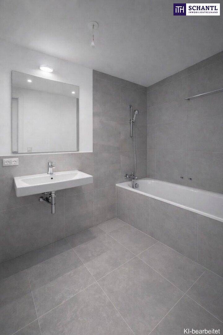 Modernes Badezimmer mit grauen Fliesen, wandhängendem Waschbecken und einer Badewanne mit Duschfunktion.