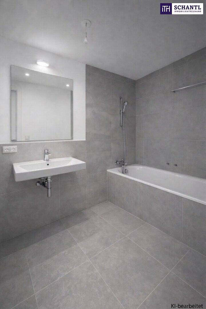 Modernes Badezimmer mit grauen Fliesen, wandhängendem Waschbecken und integrierter Badewanne mit Duschfunktion.