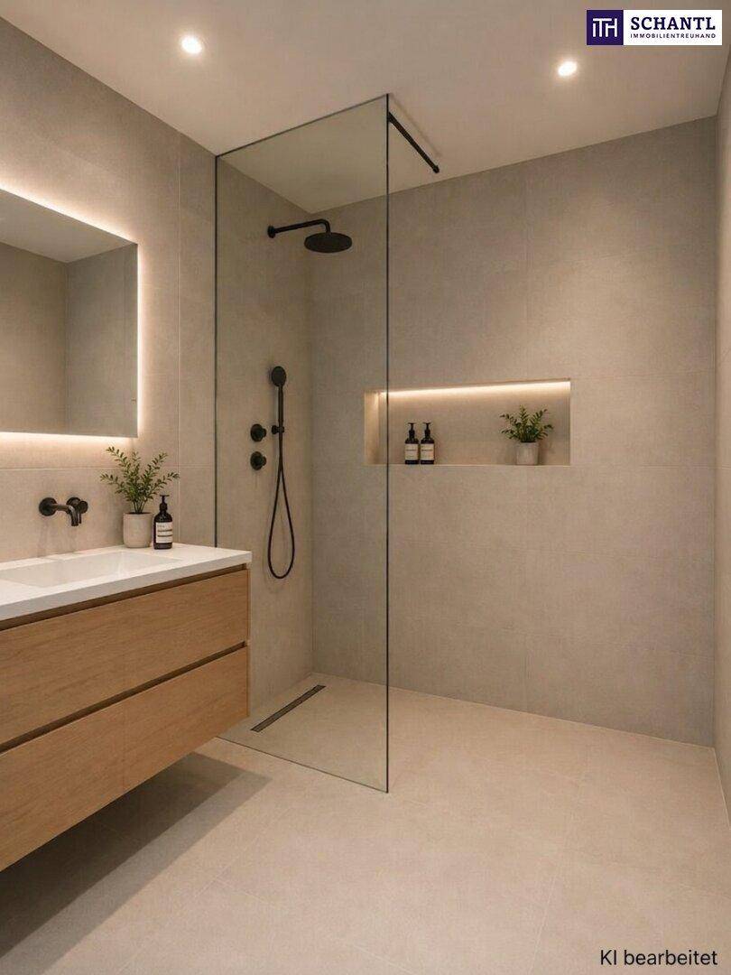 Elegantes Badezimmer mit begehbarer Dusche, Einzelwaschbecken und beleuchtetem Spiegel.