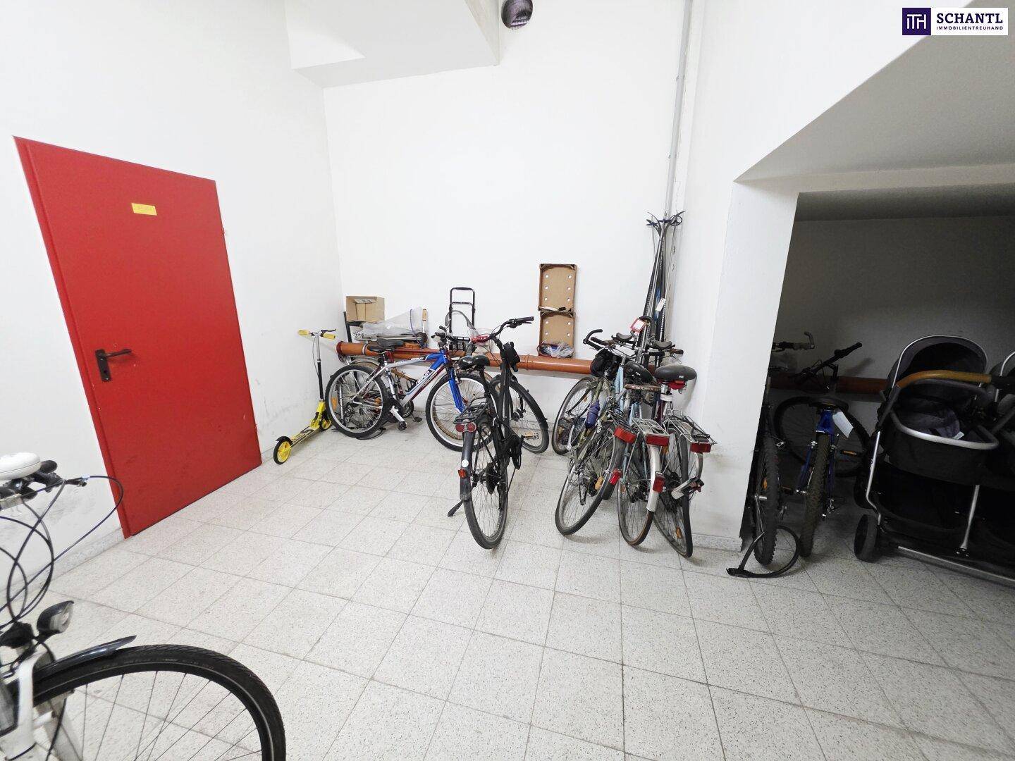 Gemeinschaftlicher Fahrradraum mit mehreren Fahrrädern und Kinderwagen, gut organisiert.