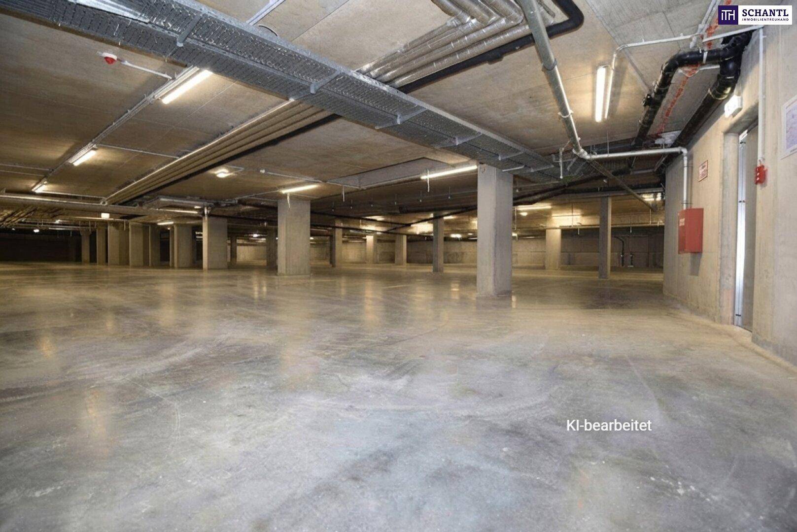 Geräumige Tiefgarage mit Betonboden und sichtbaren Installationen, bietet viel Platz für Fahrzeuge.
