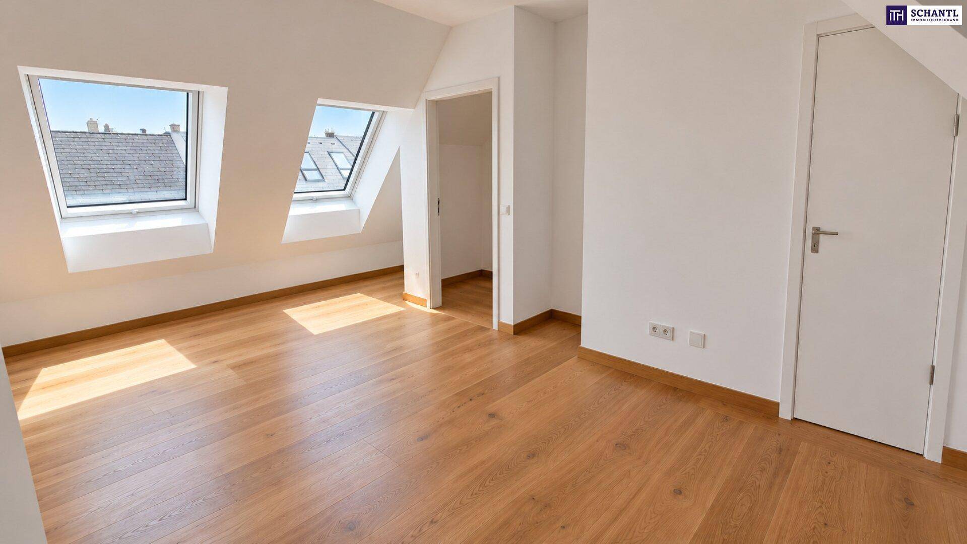 Helles Schlafzimmer im Dachgeschoss mit zwei Dachfenstern und warmem Holzparkettboden.