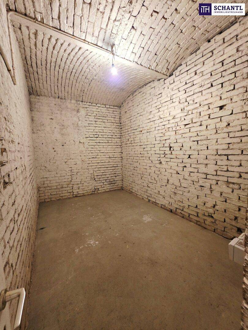 Gewölbekeller mit unverputzten, weiß gestrichenen Ziegelwänden und einem robusten Betonboden.