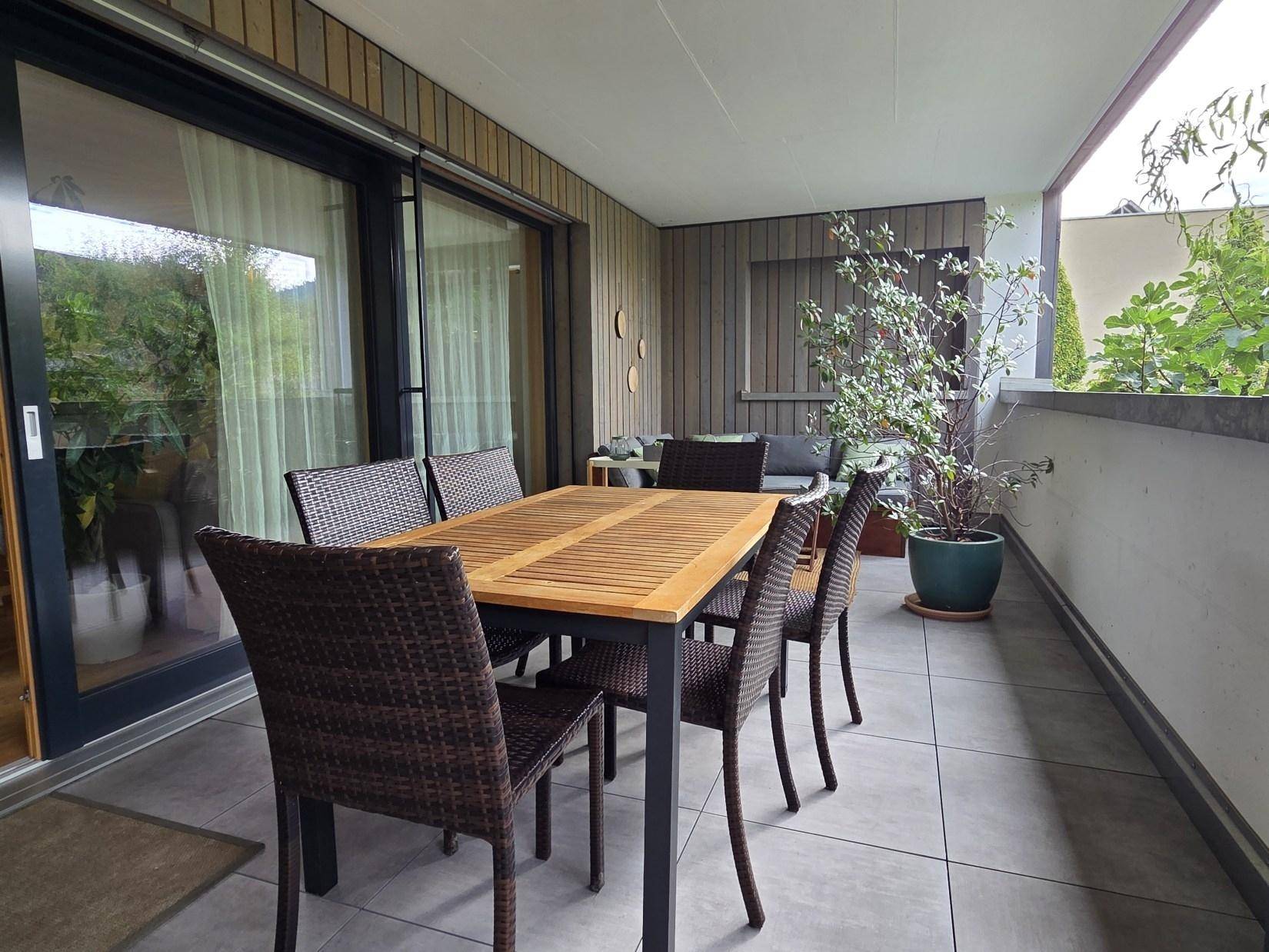 Geräumiger Balkon mit Fliesenboden und Essbereich, ideal für Mahlzeiten im Freien.