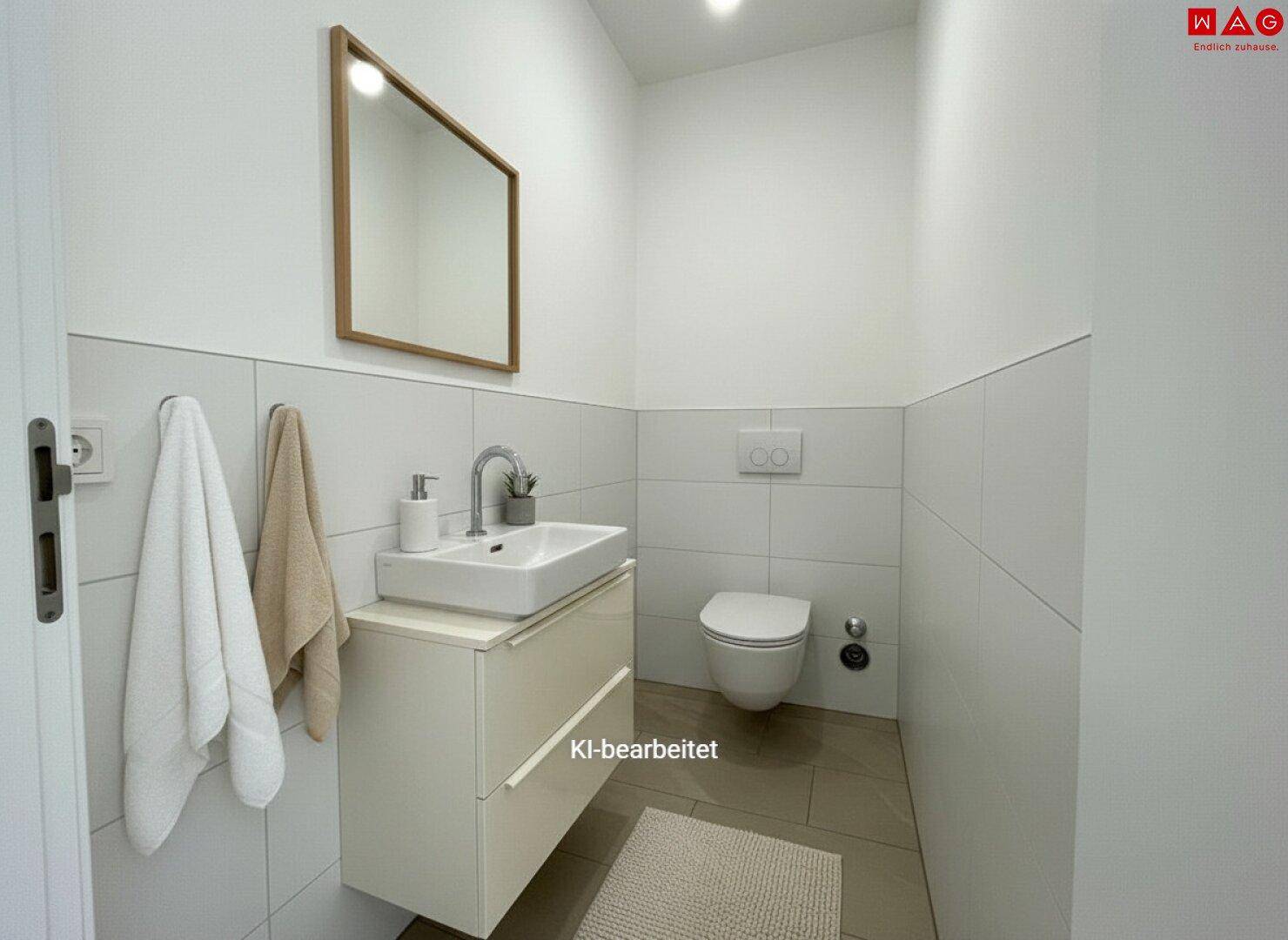 Modernes Gäste-WC mit Waschbecken und wandhängender Toilette, hell gefliest und funktional.