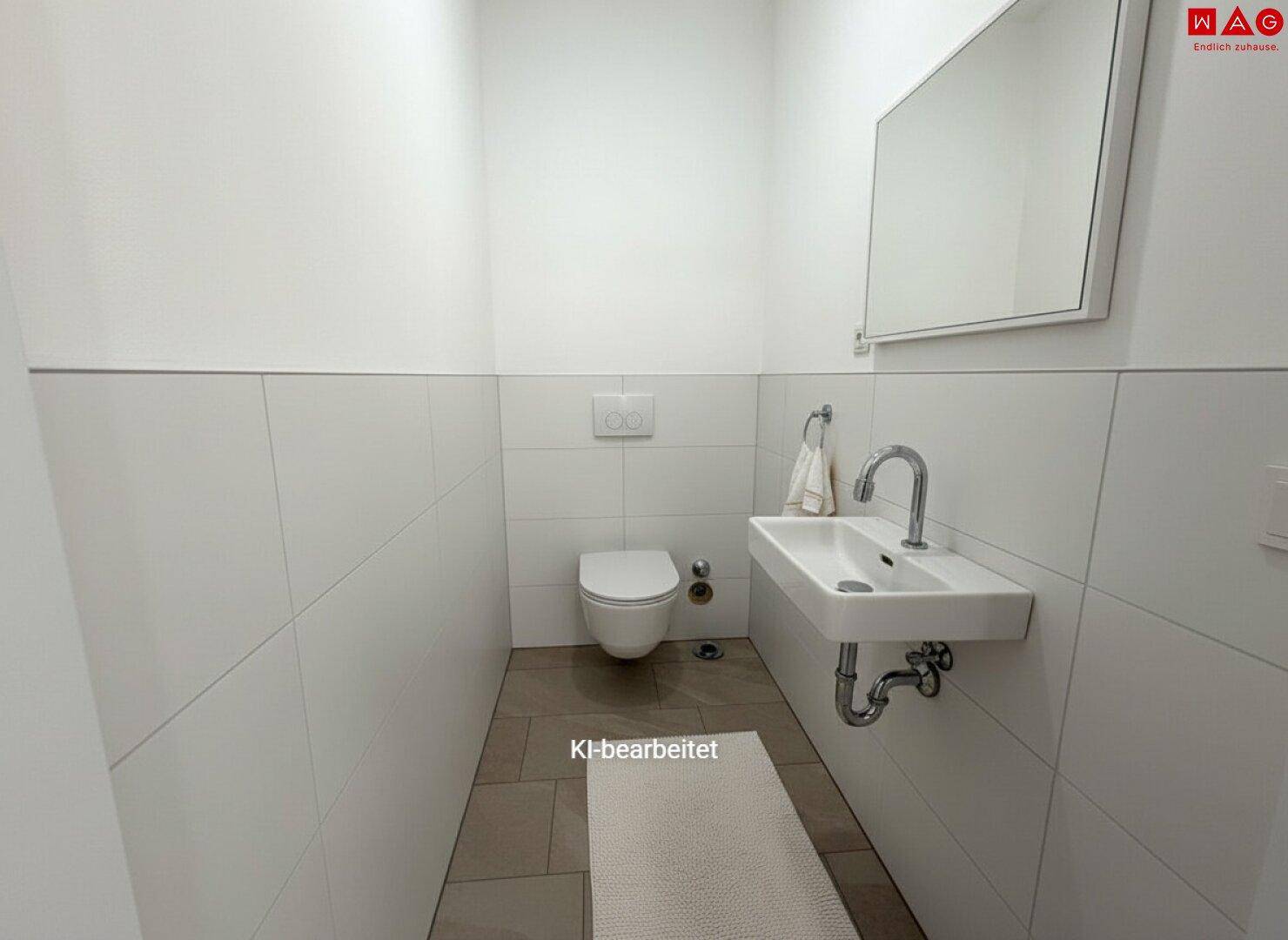 Gäste-WC mit wandhängender Toilette und modernem Waschbecken.