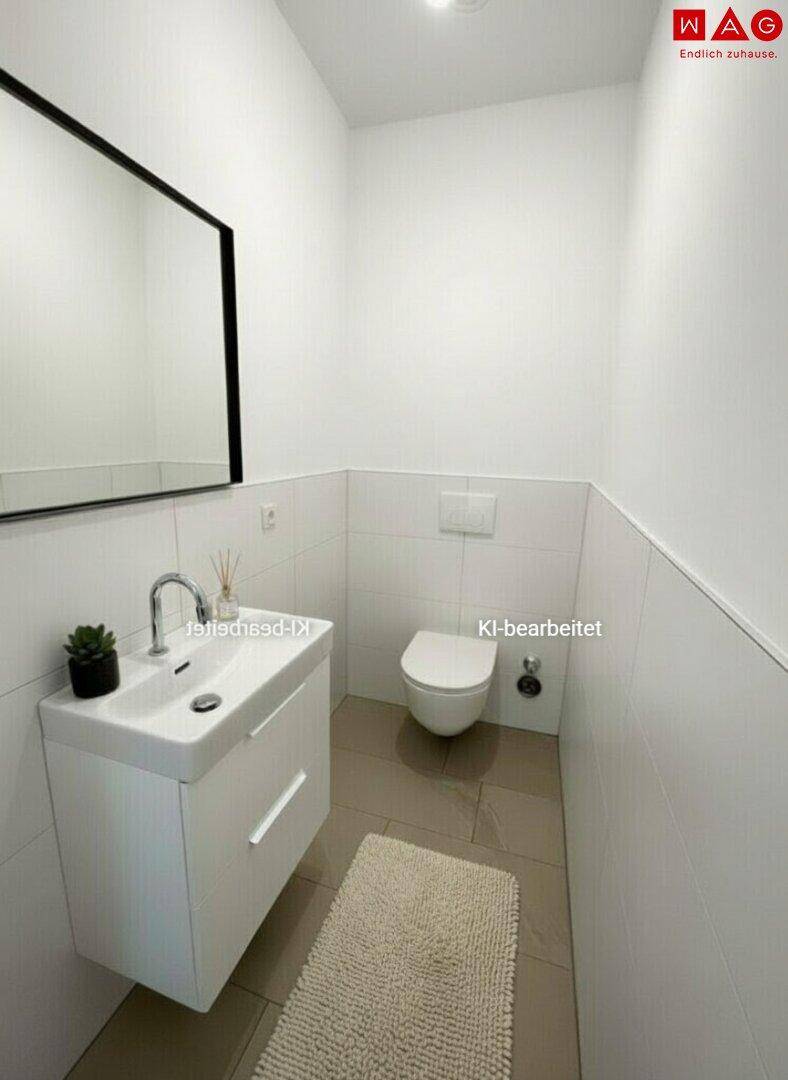Kleines Gäste-WC mit modernem Waschbecken, wandhängender Toilette und Spiegel.