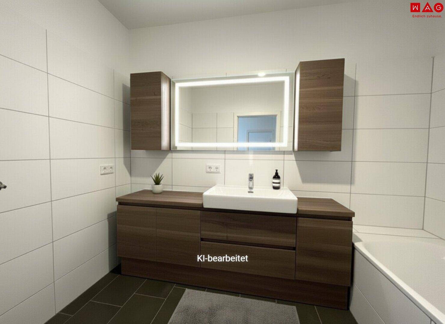 Modernes Badezimmer mit Waschtischunterschrank, beleuchtetem Spiegelschrank und Badewanne.