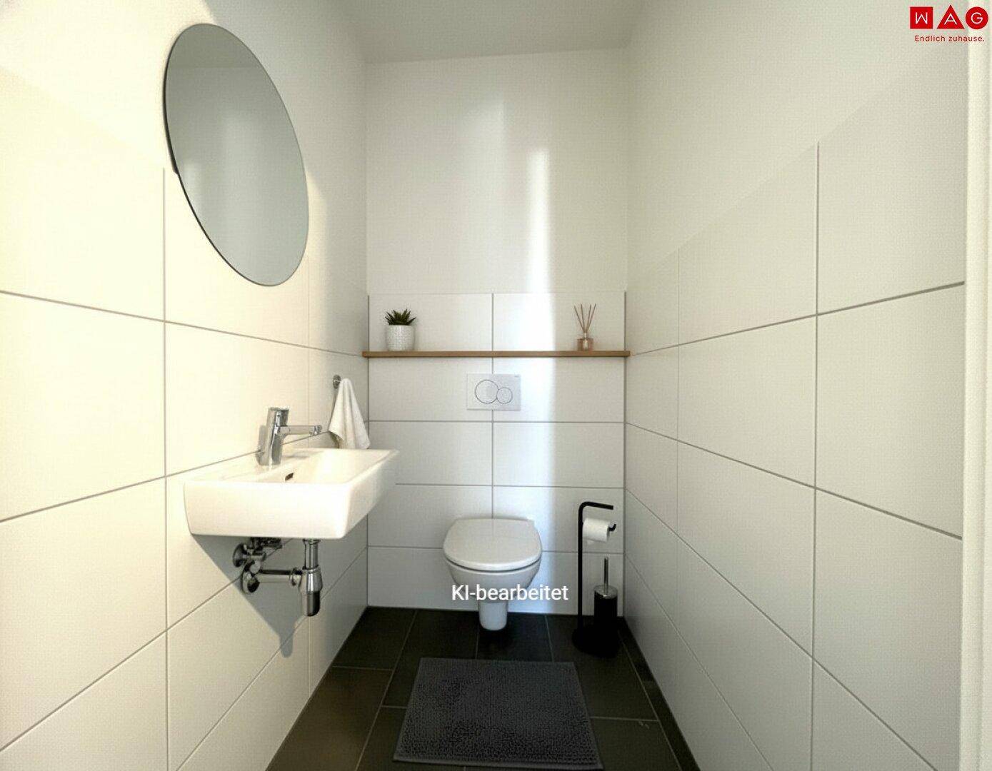 Gepflegtes Gäste-WC mit Wand-WC, kleinem Waschbecken und modernem Spiegel.