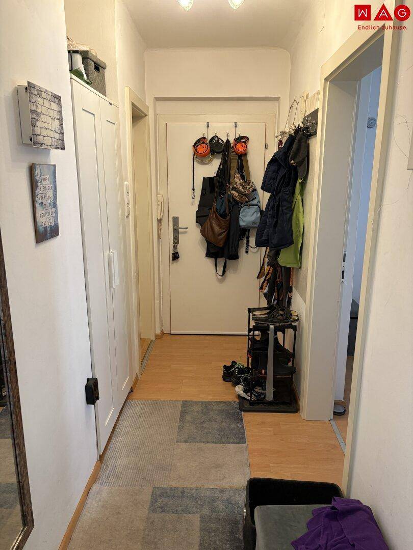 Heller Flur mit Garderobe, Schuhregal und praktischem Stauraum.