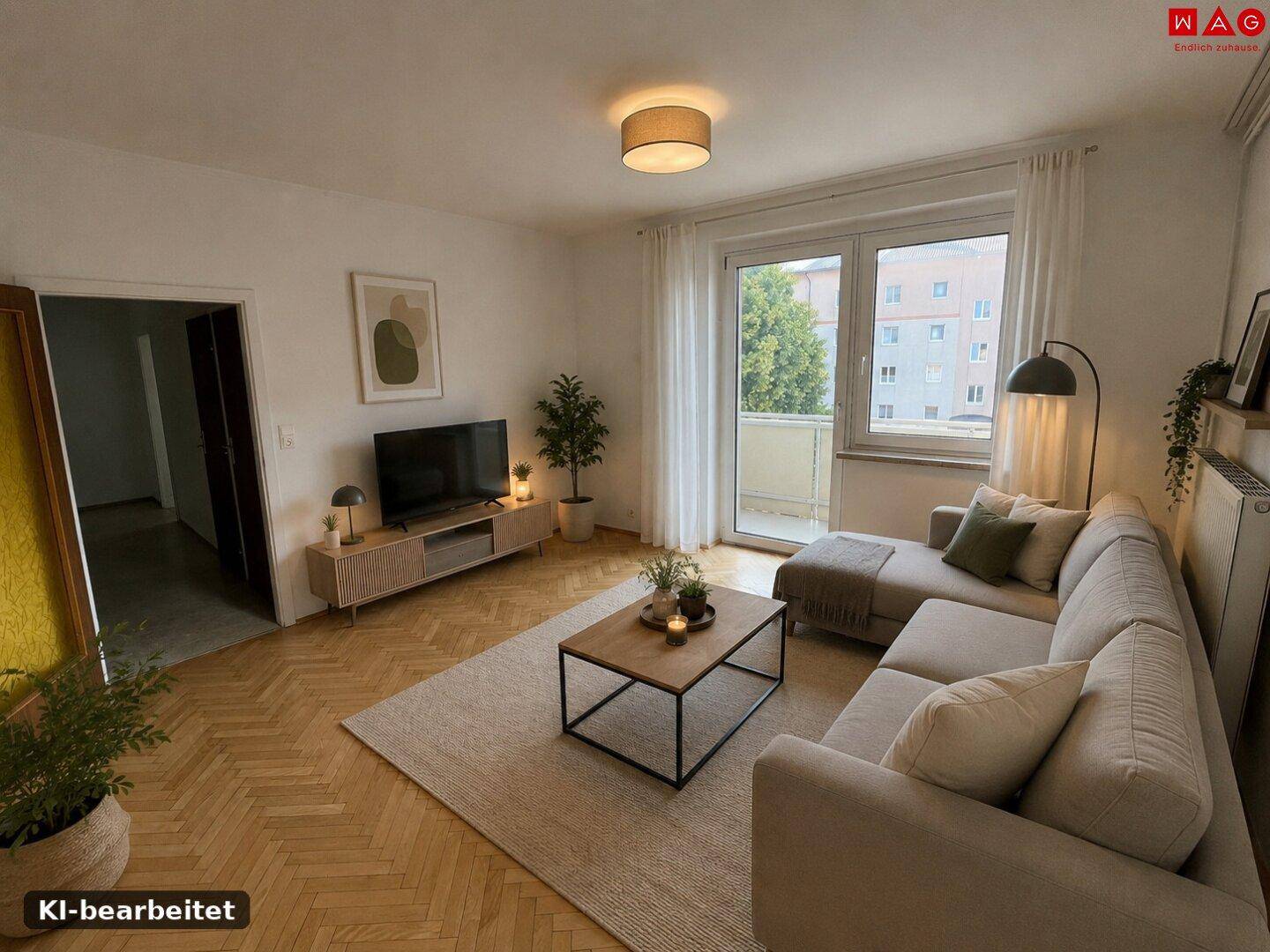 Modern eingerichtetes Wohnzimmer mit Sofa, Couchtisch und Balkonzugang.