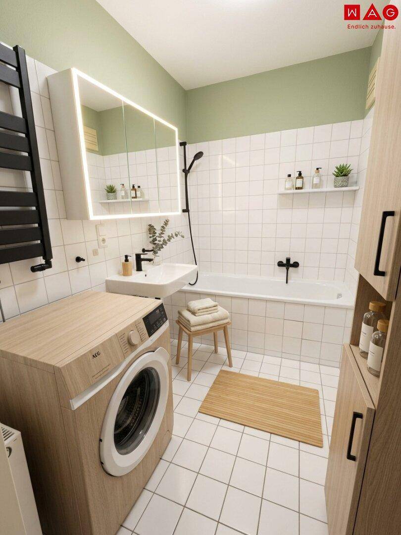 Modernes Badezimmer mit Badewanne, Waschmaschine und beheiztem Handtuchhalter, in hellen Farben gehalten.