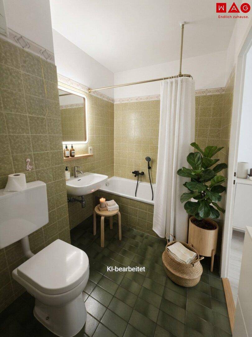 Badezimmer mit grünen Fliesen, Badewanne und WC, ausgestattet mit einem Waschbecken.