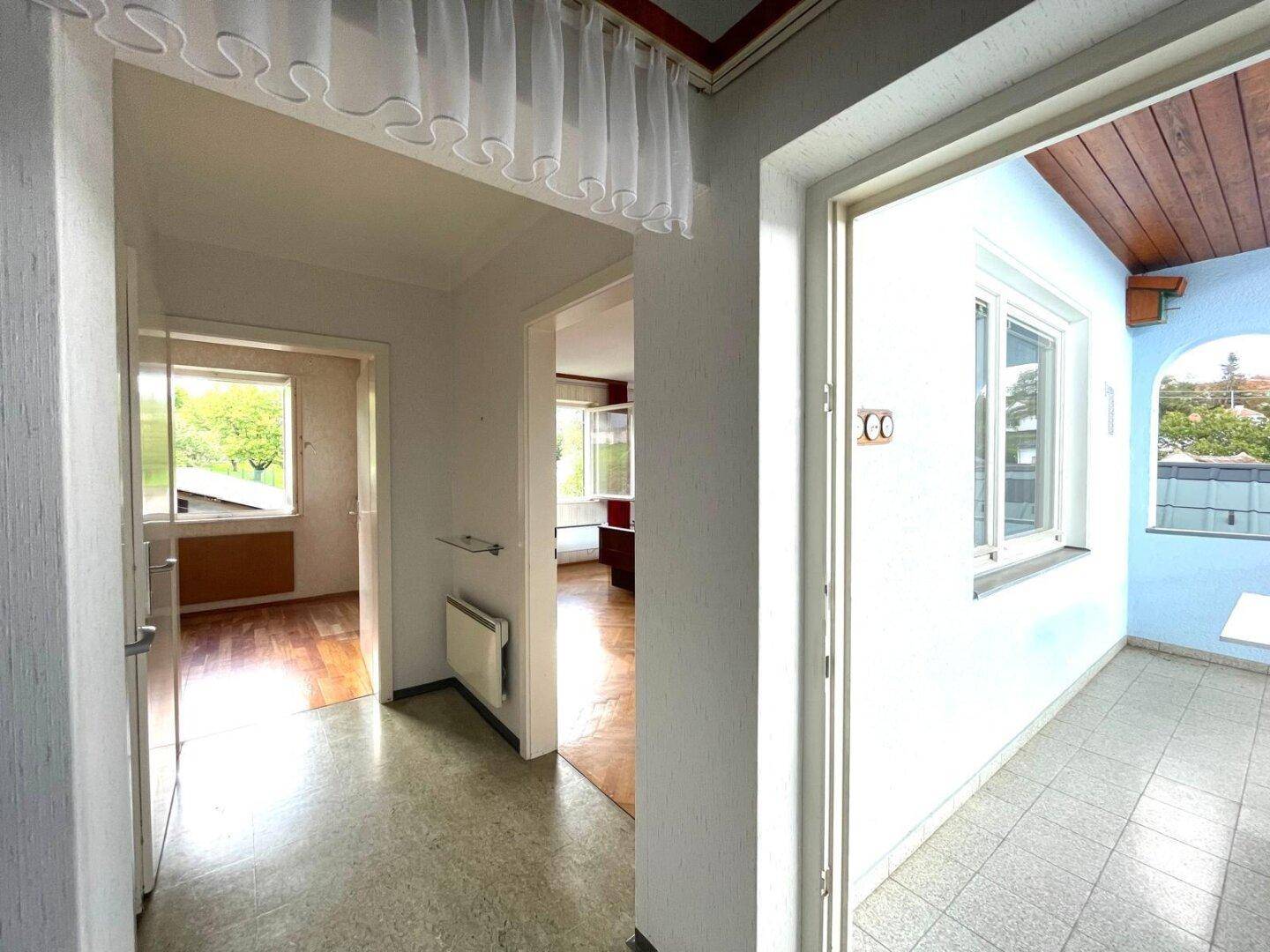 Flur mit Zugang zu verschiedenen Räumen und einem Balkon.