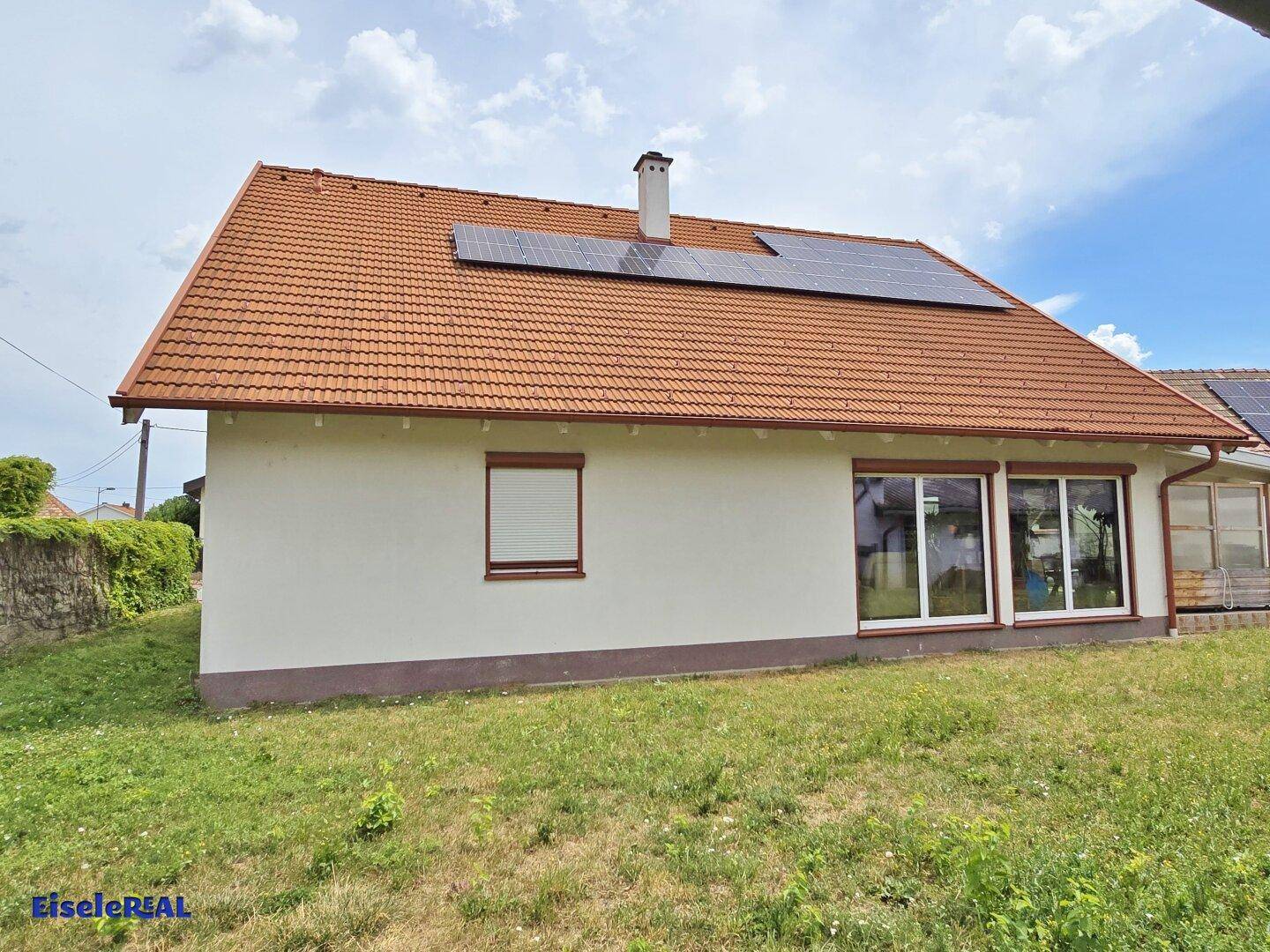 Rückansicht des Hauses mit Photovoltaikanlage auf dem Ziegeldach.