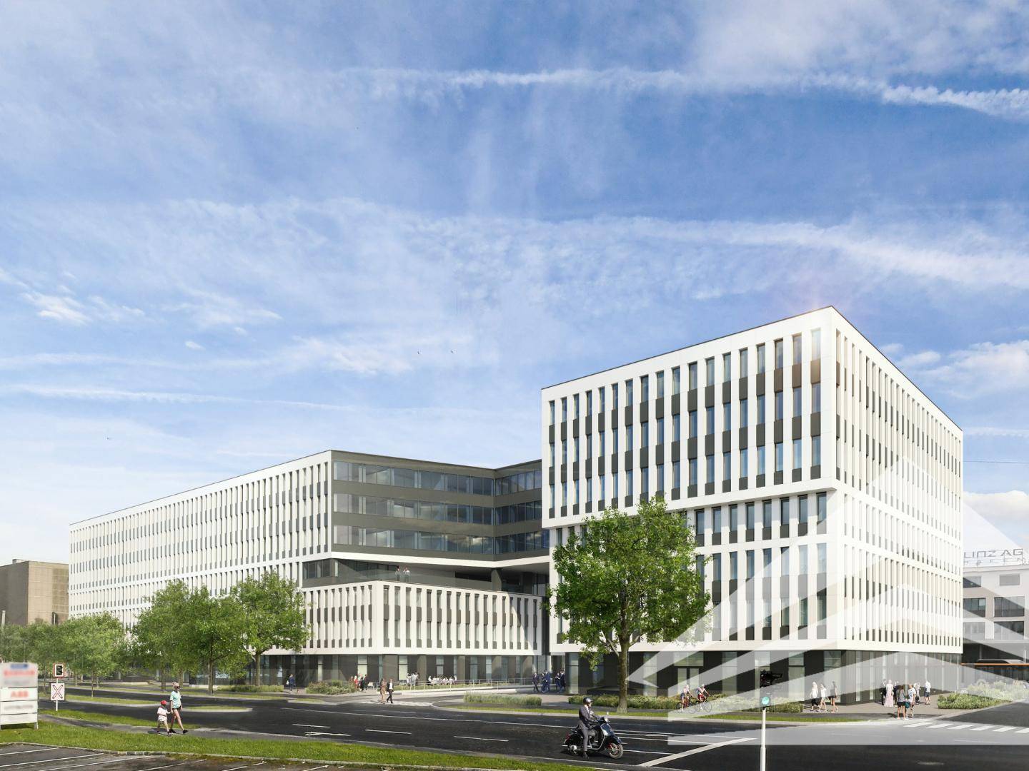 Weitläufiger moderner Bürokomplex mit mehreren Gebäudeteilen, umgeben von Grünflächen und städtischer Infrastruktur.