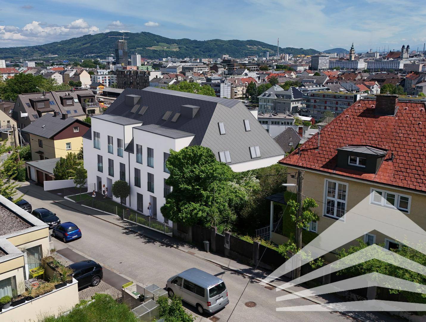Luftaufnahme des modernen Gebäudes in einer städtischen Umgebung mit Blick über die Dächer der Stadt.