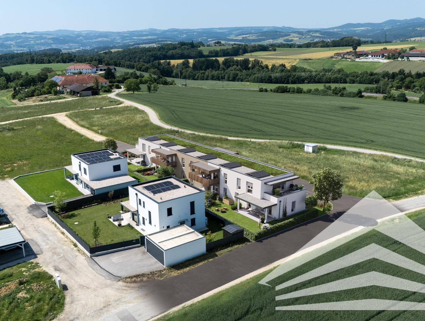 Vogelperspektive einer modernen Wohnsiedlung mit Einfamilienhäusern und Reihenhäusern in grüner Landschaft.