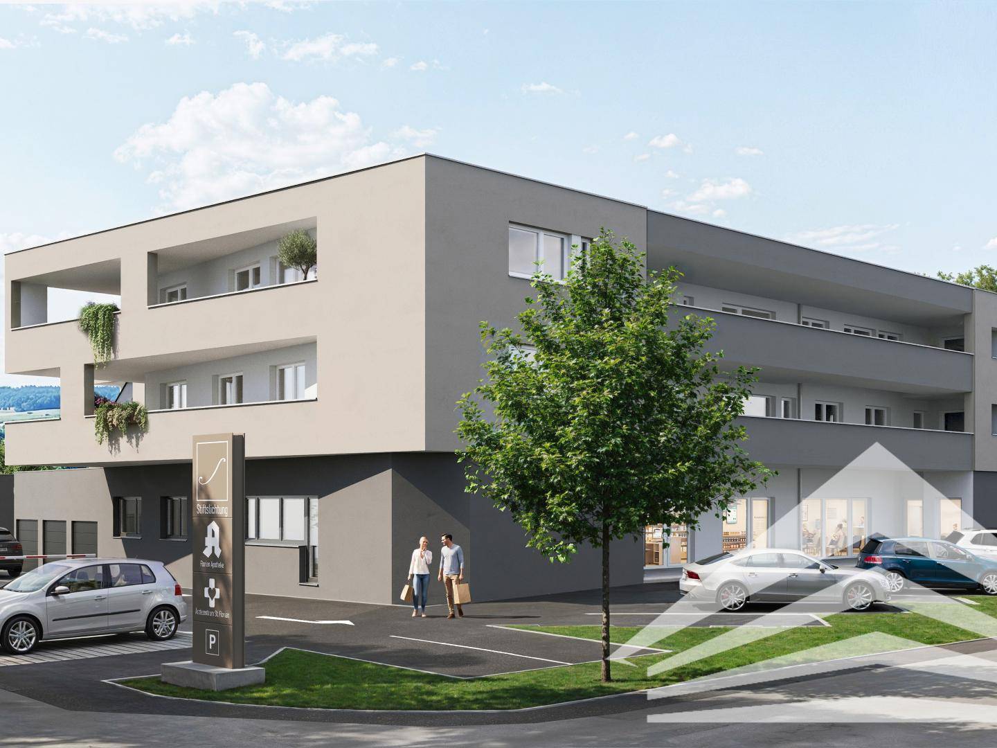 Moderne Wohn- und Geschäftsanlage mit Apotheke im Erdgeschoss und Außenparkplätzen.