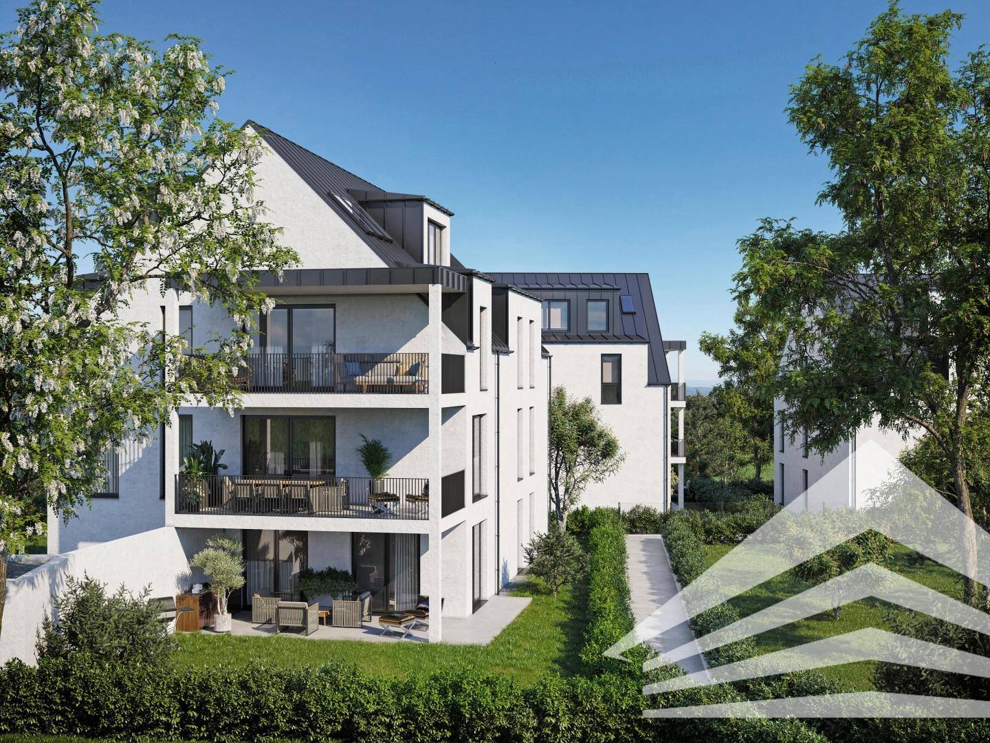 Seitenansicht der modernen Gebäude mit Balkonen, Terrassen und gepflegten Hecken.
