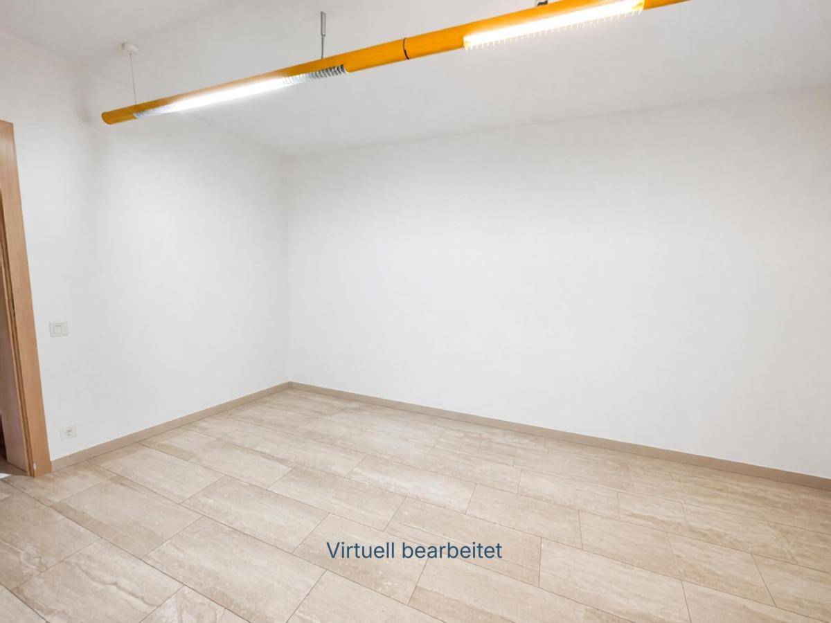Leerer Raum mit gefliestem Boden und weißen Wänden, bereit für individuelle Gestaltung.