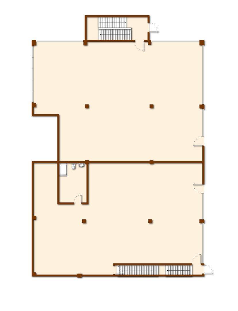 Grundriss einer Etage mit großen, offenen Flächen, einem WC und zwei Treppenhäusern.