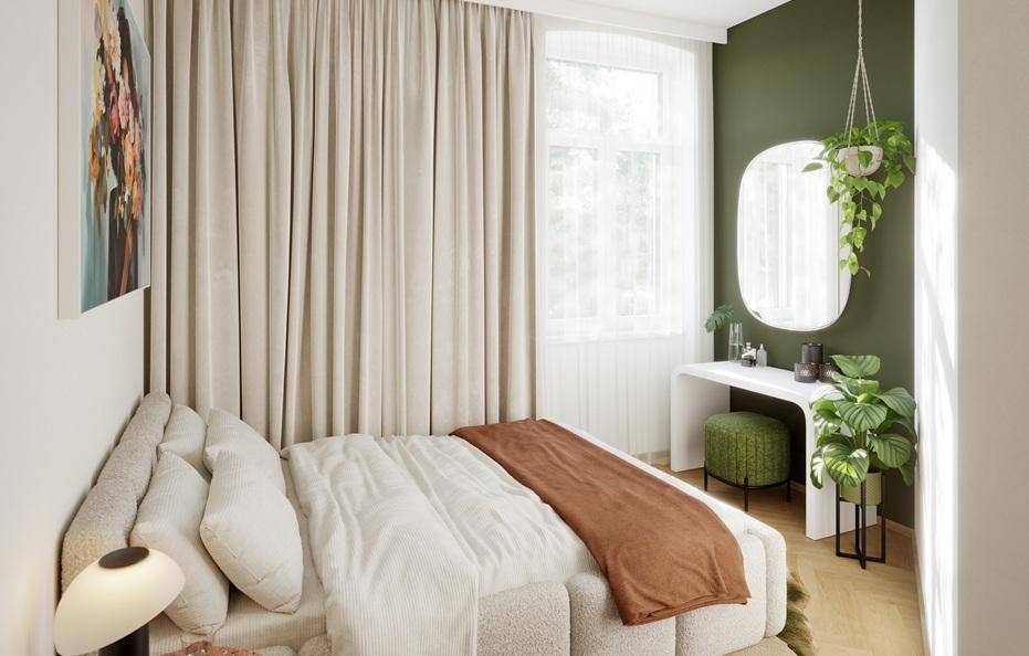 Gemütliches Schlafzimmer mit grün gestrichener Wand, großem Bett und einem eleganten Schminktisch.