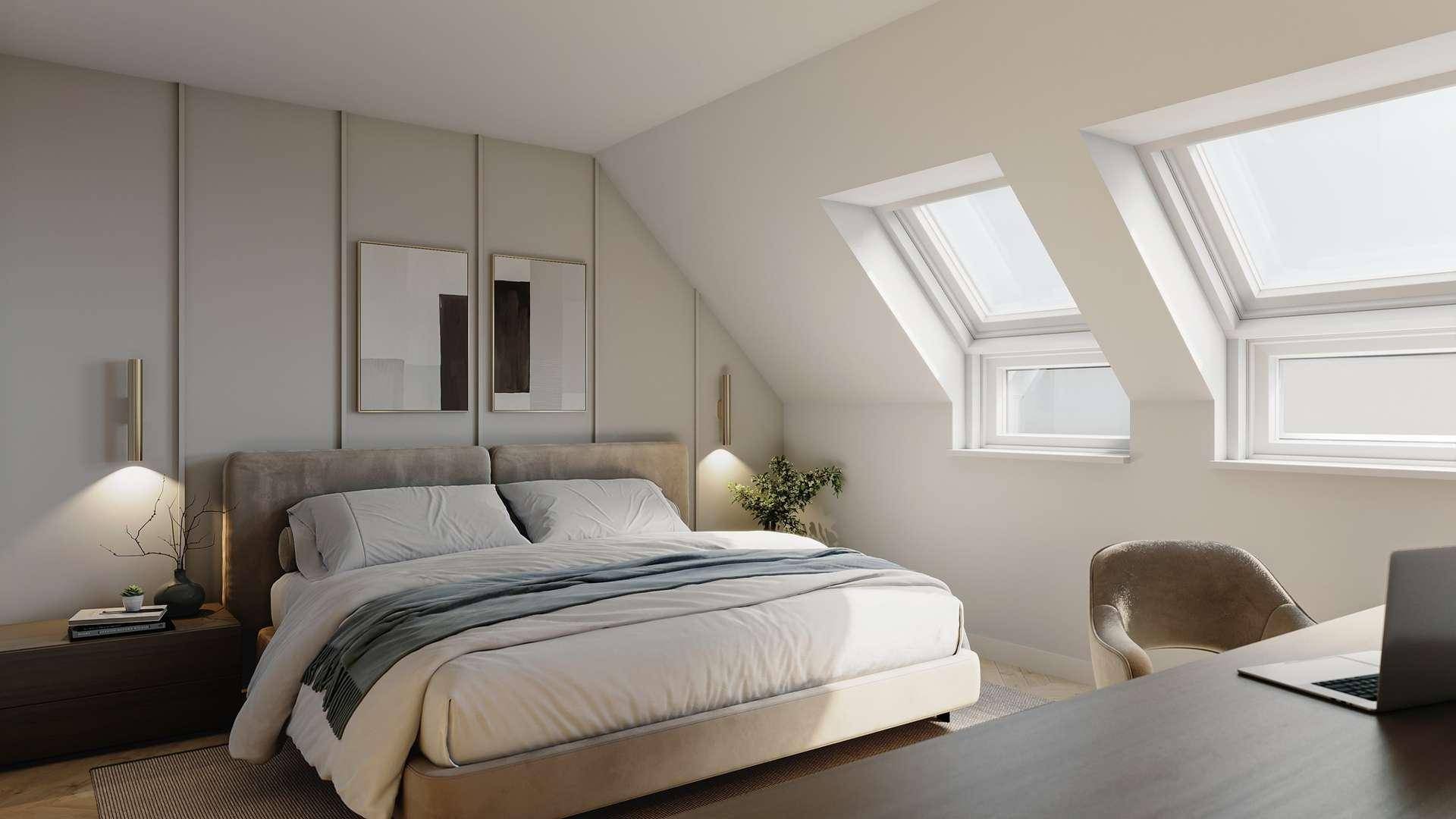 Helles Schlafzimmer mit modernem Bett, Schreibtischbereich und Dachfenstern unter einer Dachschräge.