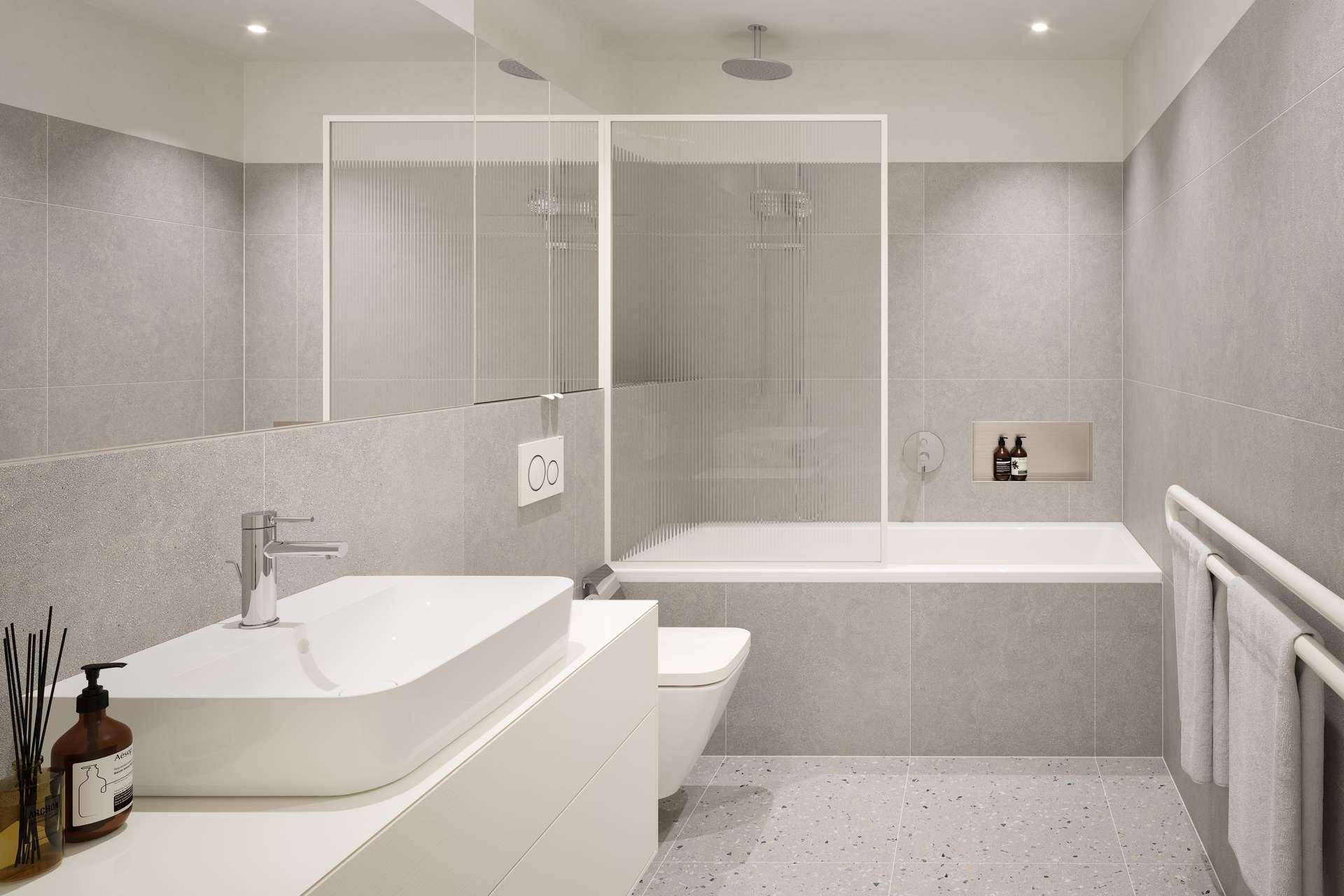 Modernes Badezimmer mit grauen Fliesen, Badewanne und integrierter Dusche sowie einem beheizten Handtuchhalter.