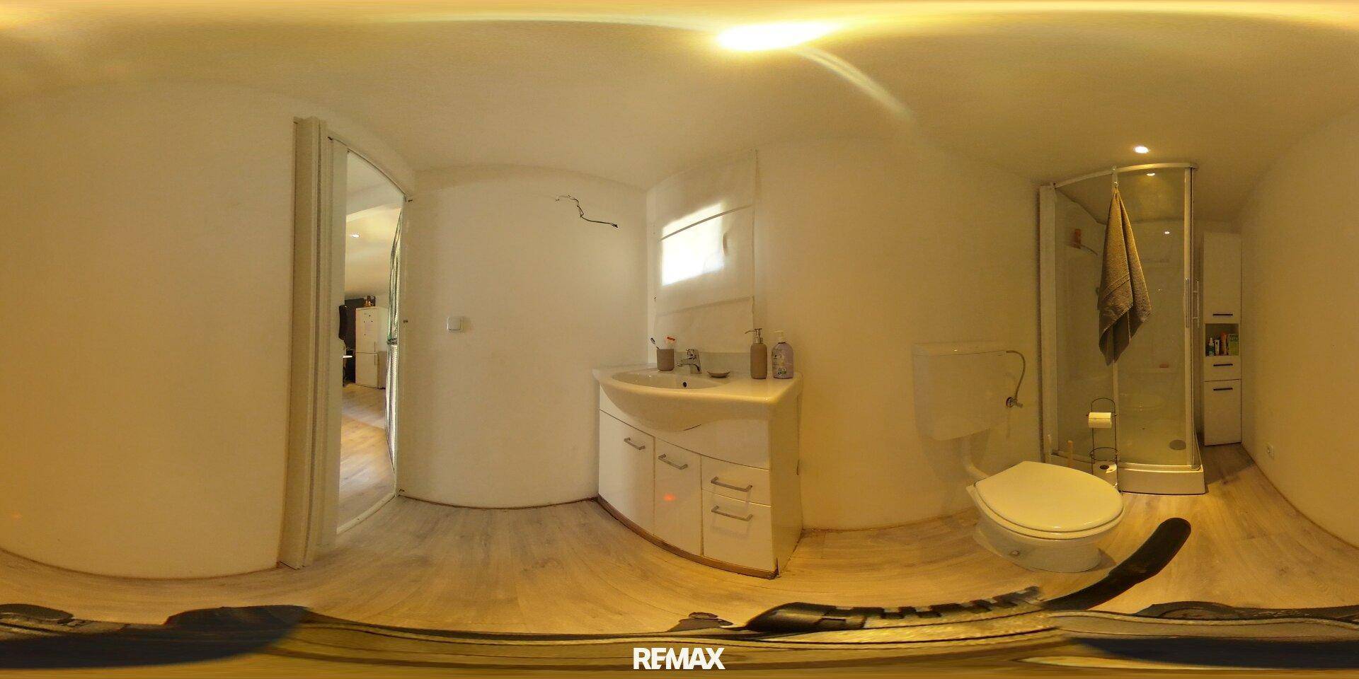 Modernes Badezimmer mit Dusche, Waschbecken und Toilette in einer 360-Grad-Ansicht.