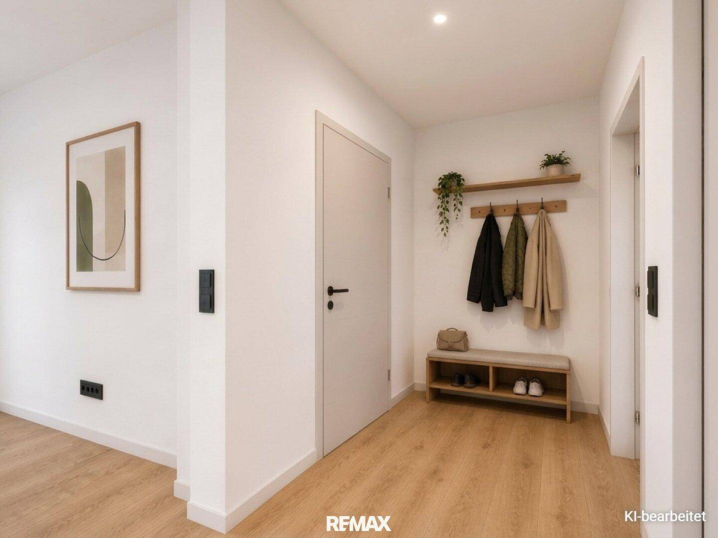 Heller Eingangsbereich mit Garderobe, Schuhbank und modernem Laminatboden.