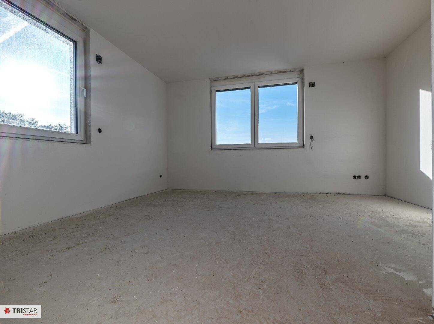 Geräumiges, unfertiges Zimmer mit zwei Fenstern, ideal für Schlafzimmer oder Arbeitszimmer.