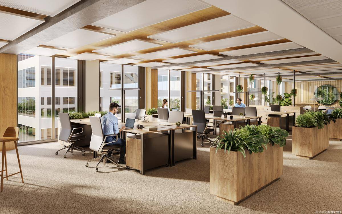 Geräumiges Großraumbüro mit ergonomischen Arbeitsplätzen und Pflanzen für eine angenehme Arbeitsatmosphäre.