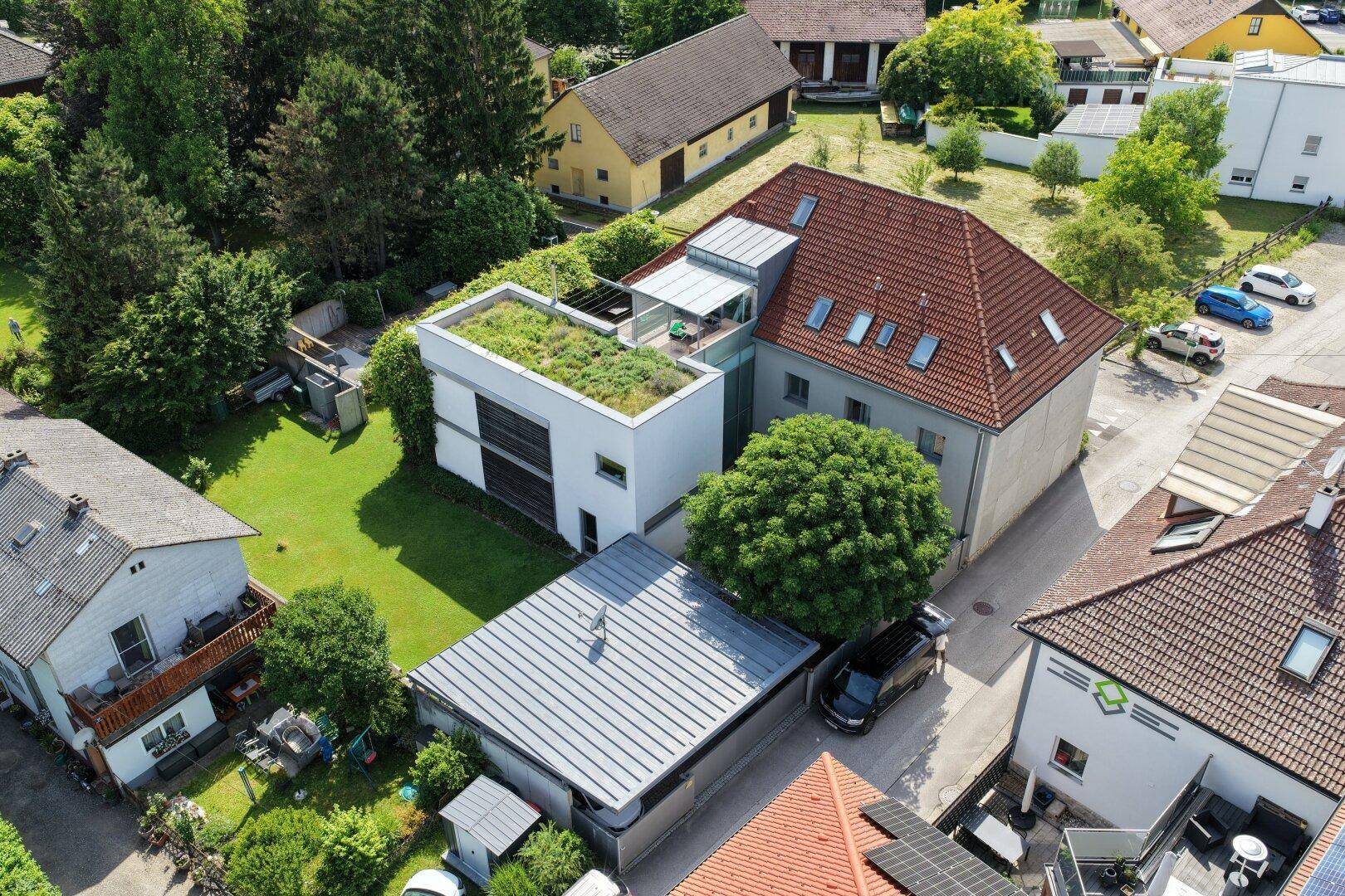 Vogelperspektive des Anwesens mit großem Garten, Pool und angrenzenden Gebäuden.